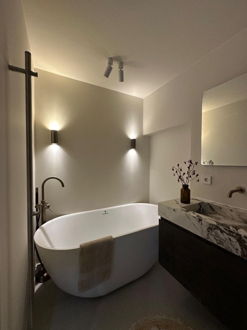 Bathroom with a freestanding bath and marble vanity unit