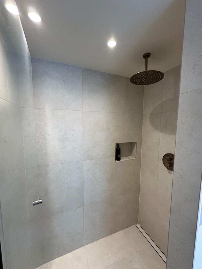 Spacious walk-in shower with a rain head