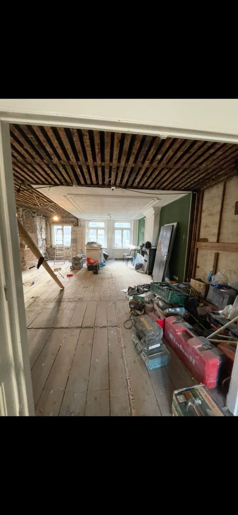 Apartment in central Amsterdam during renovation, with the old timber floor structure exposed