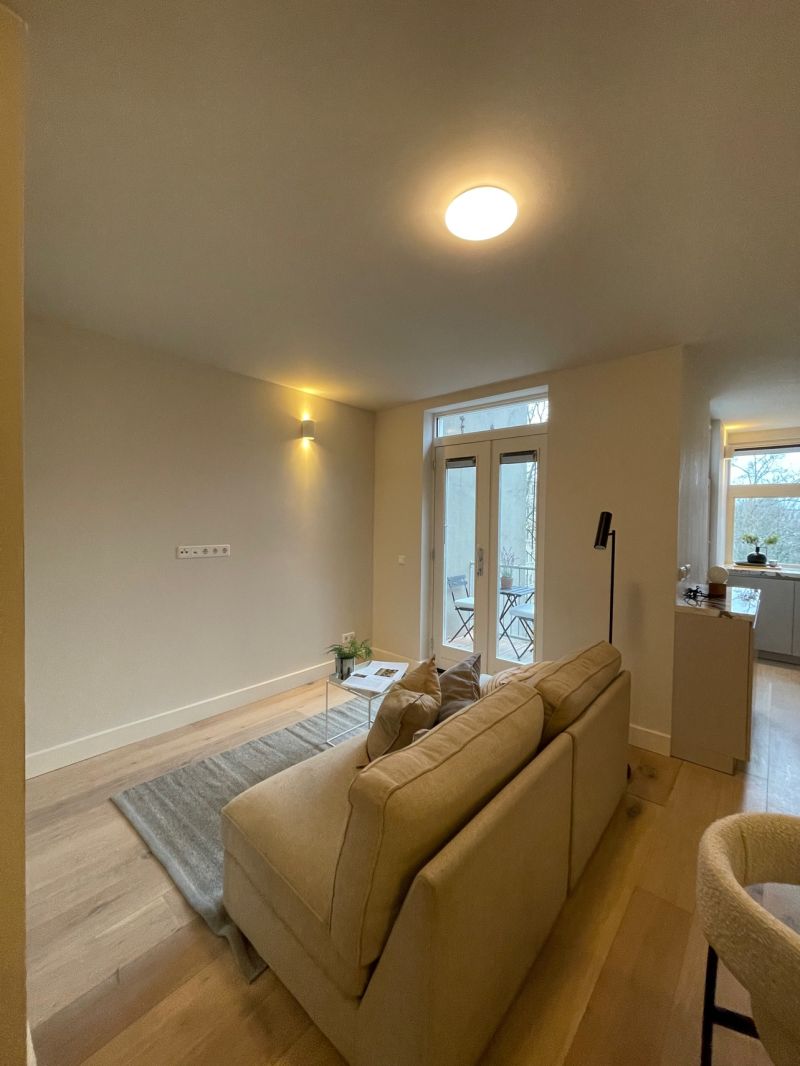 New kitchen with a cooking island and herringbone floor after the full renovation