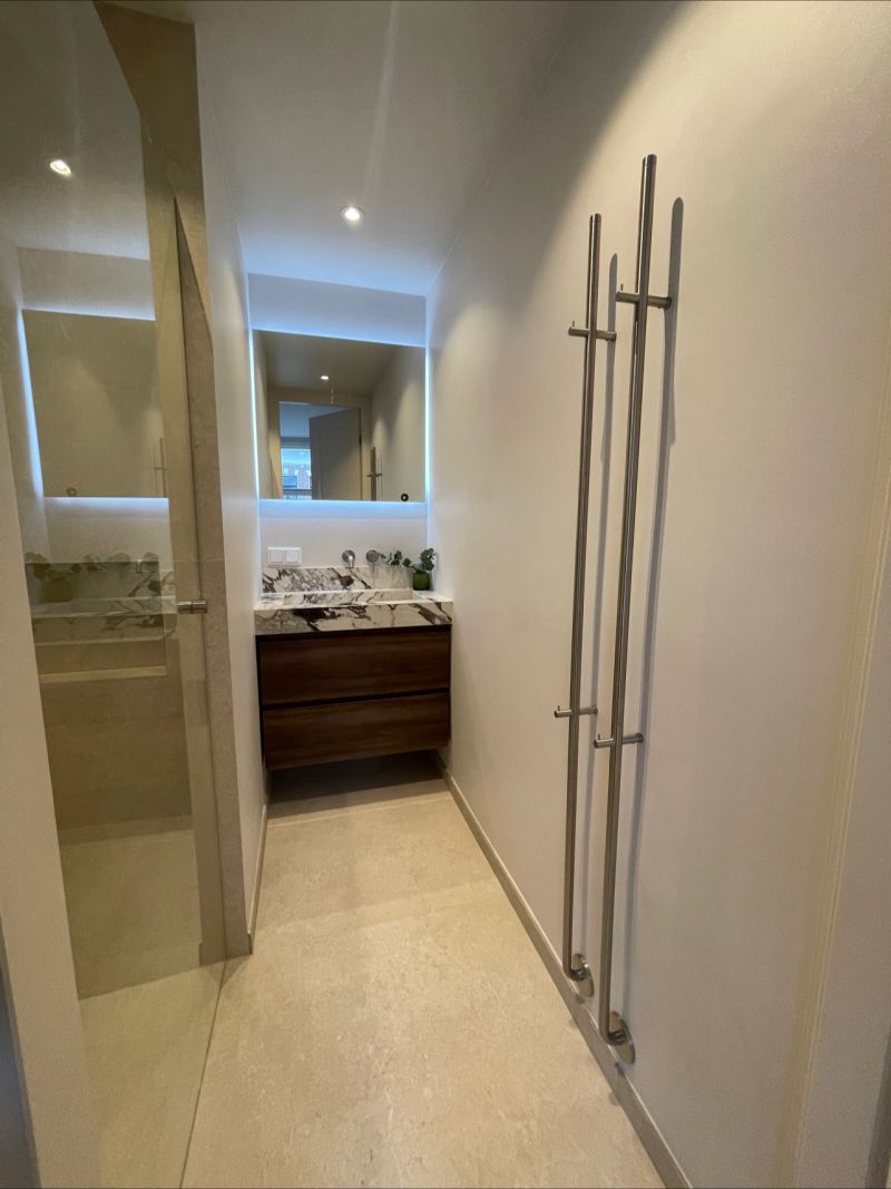 Bathroom with a marble vanity top and walk-in shower