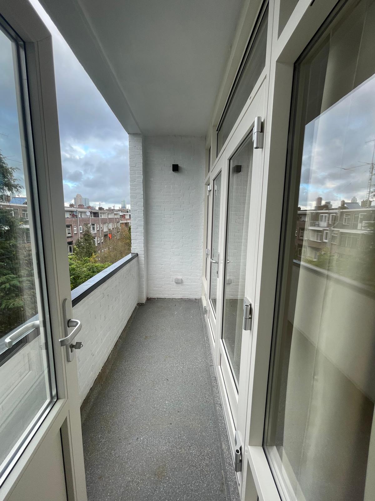 New window frames and loggia with a view over Rotterdam in the Tarwewijk